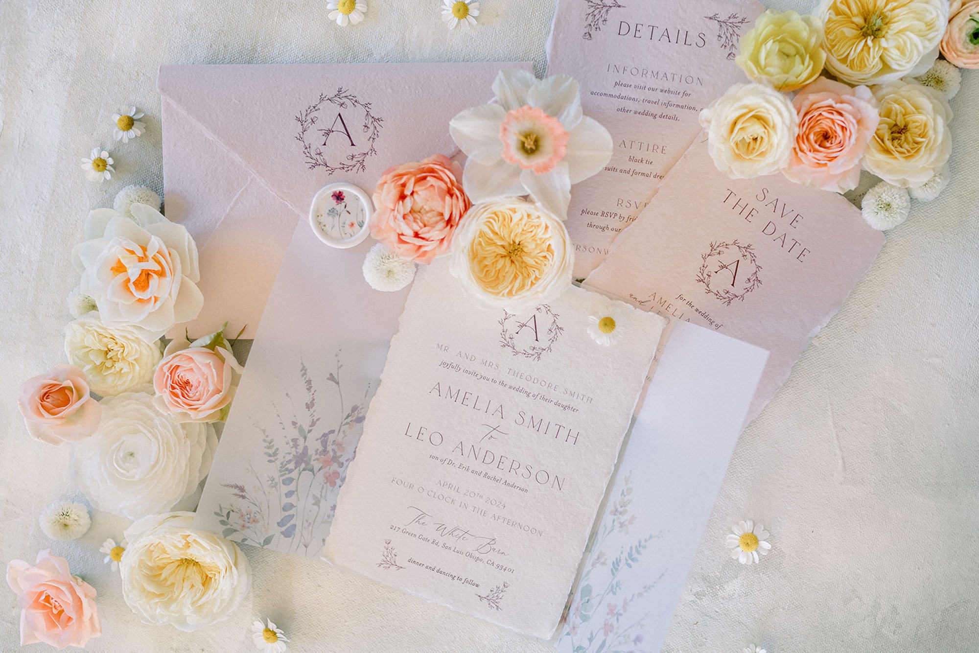 Romantic pastel wedding invitation suite styled with blush deckle paper, floral details card, and spring blooms for a fine art wedding at The White Barn in SLO.