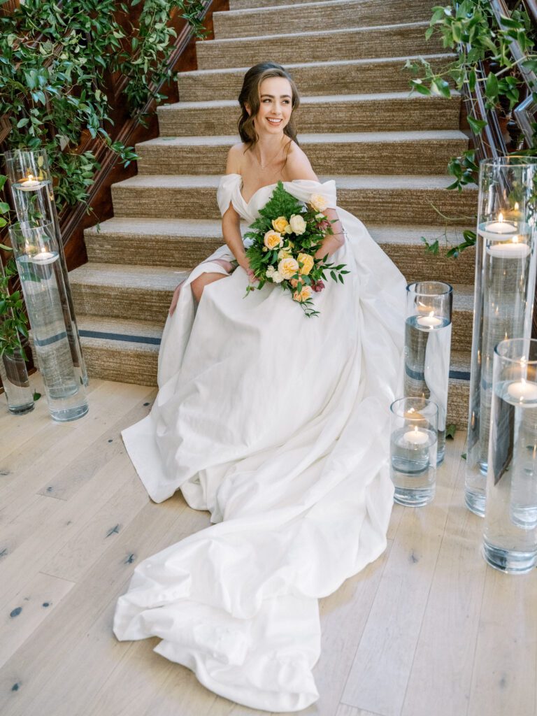 Bride descending historic staircase in Regency-inspired gown