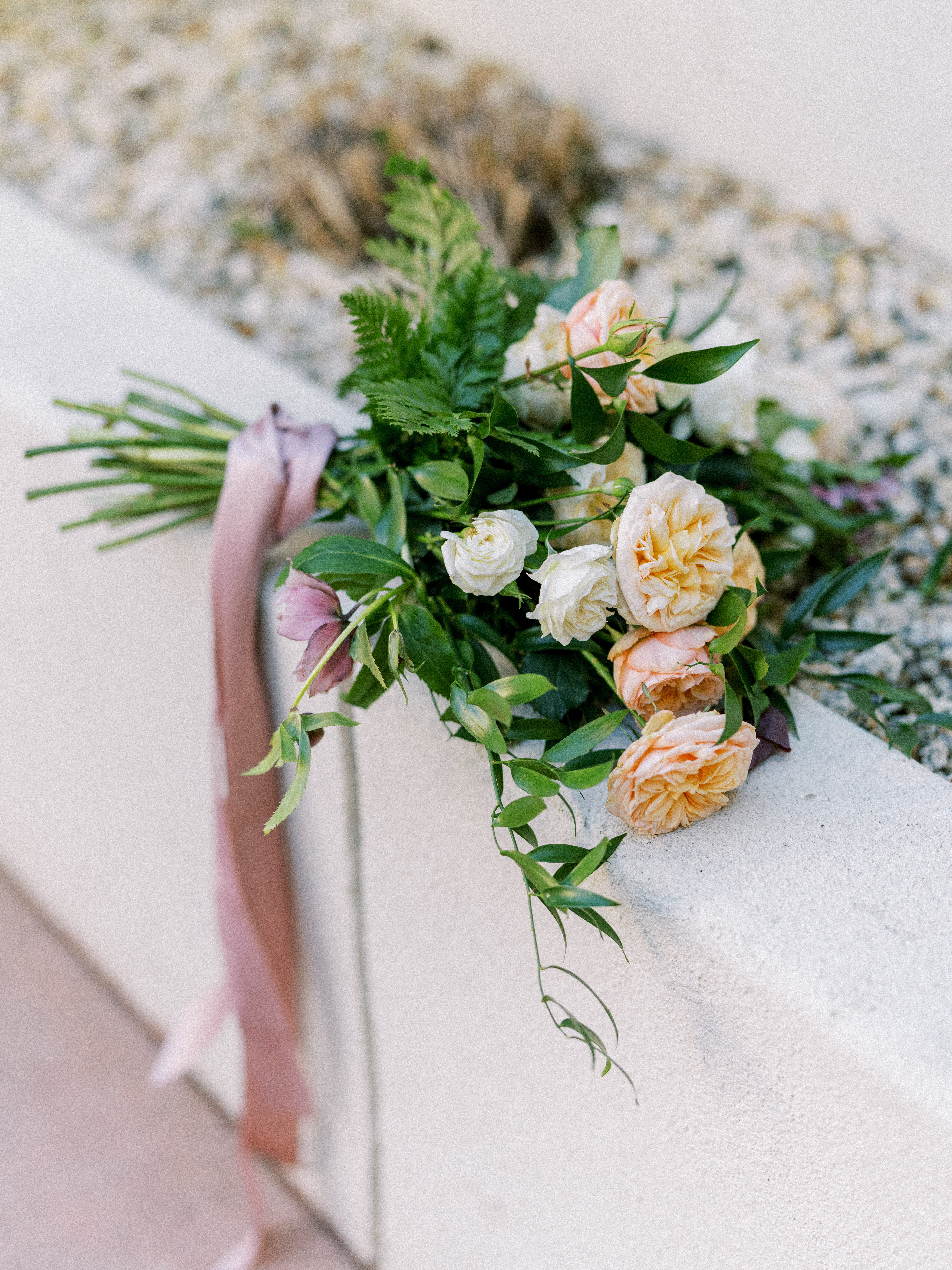 Bridal bouquet styled with blush ribbon