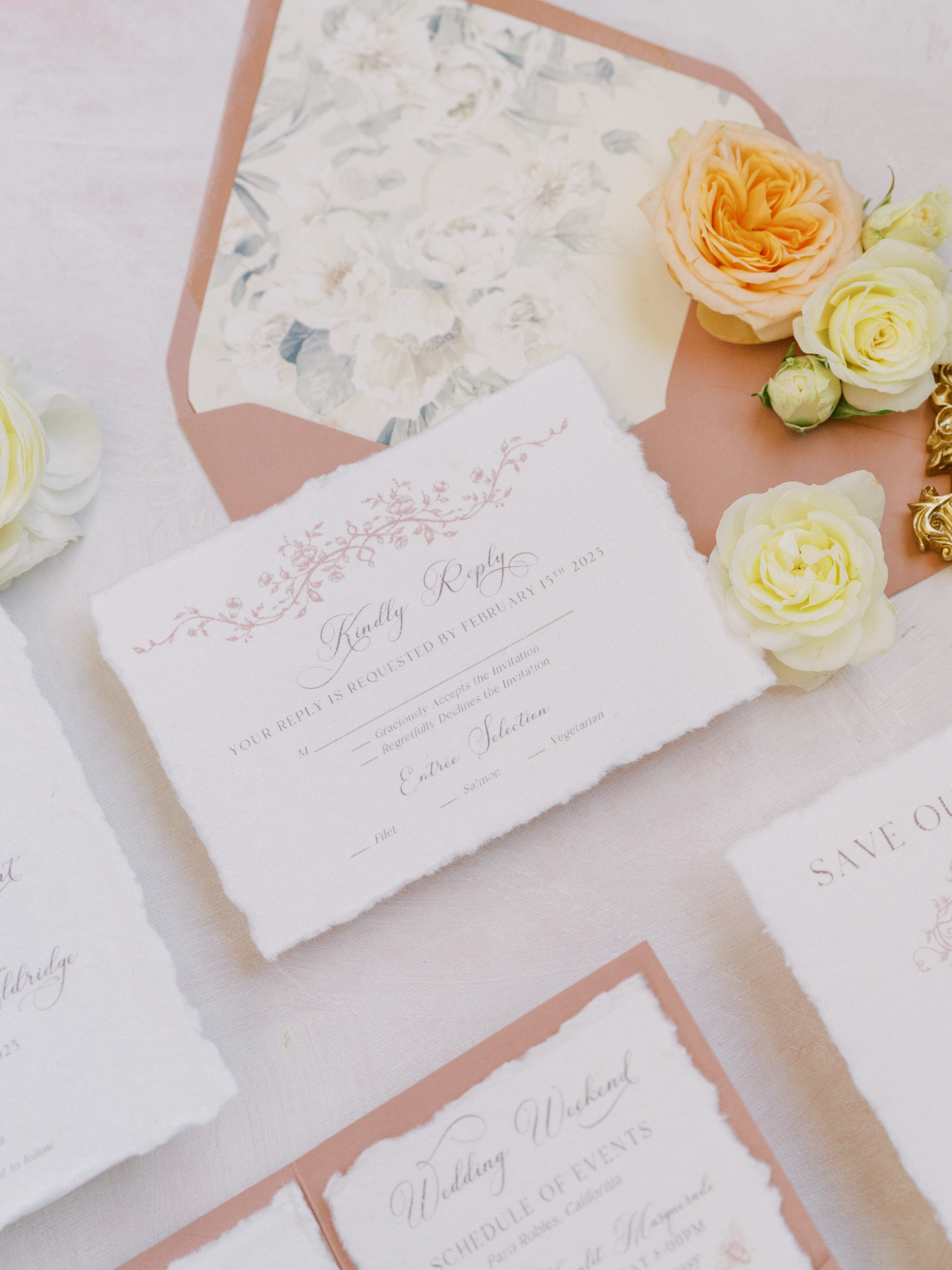 Regency-inspired wedding stationery flat lay with blush tones, florals, and antique details