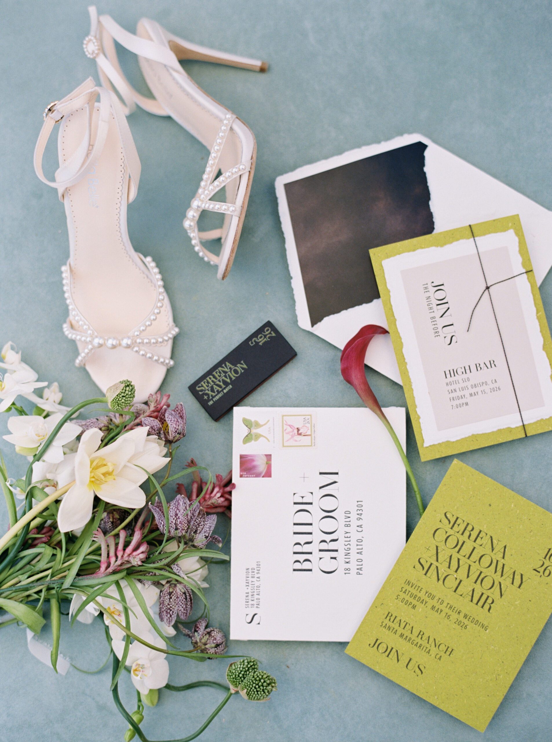 Modern green wedding invitation suite with pearl bridal shoes, florals, and handmade paper details at Riata Ranch