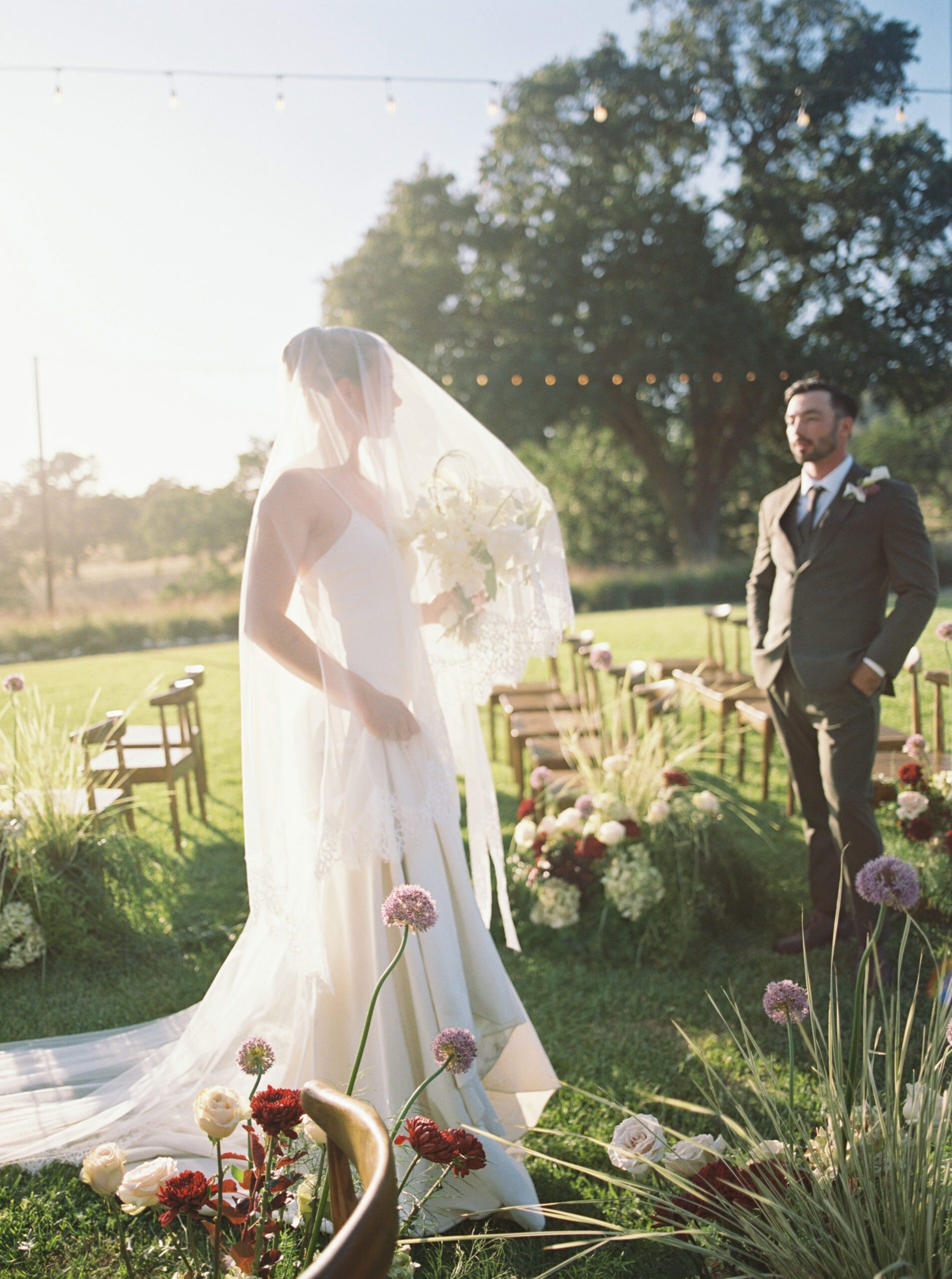 Bride and groom at an outdoor wedding ceremony surrounded by modern floral arrangements at Riata Ranch