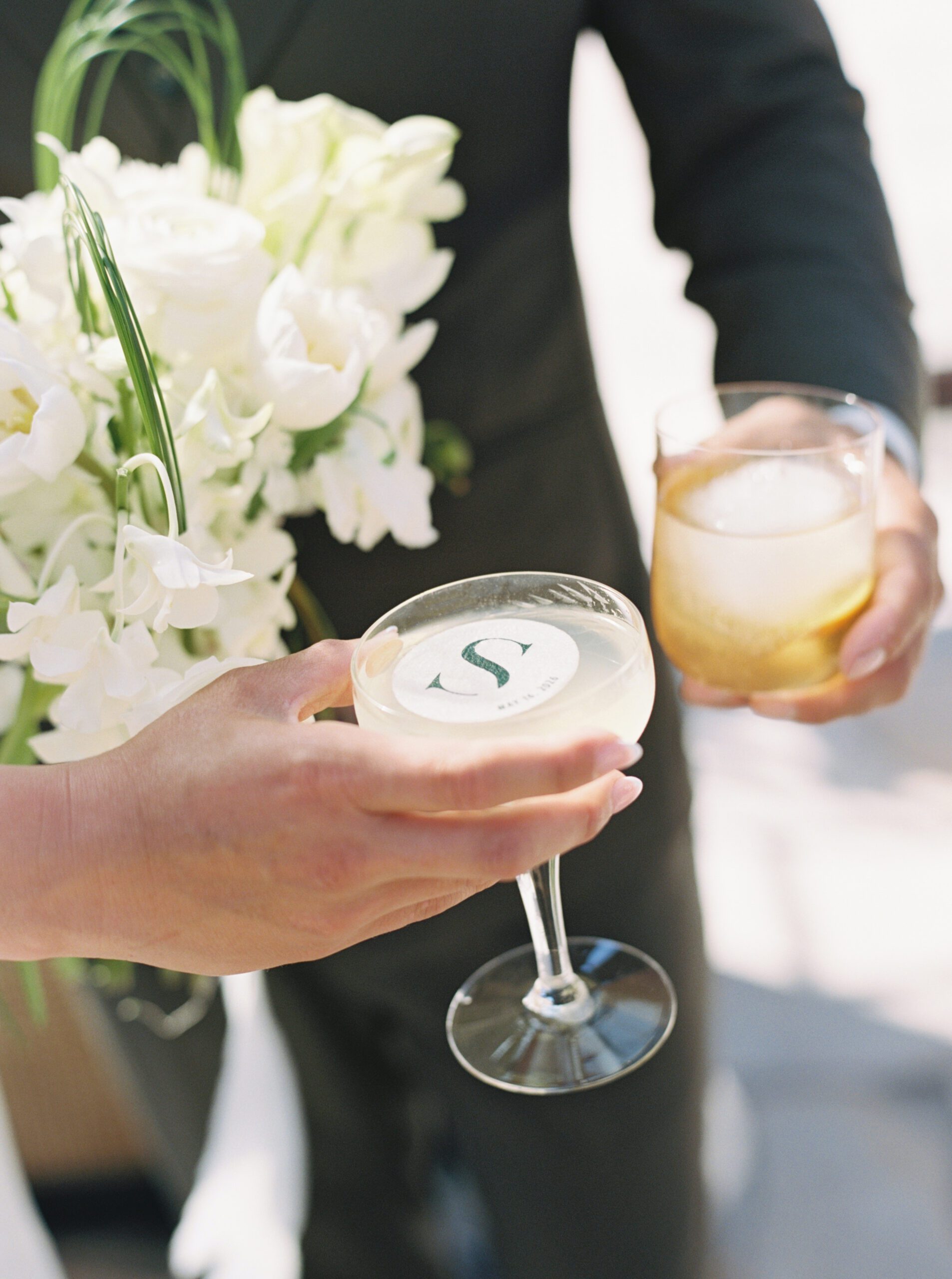 Wedding signature cocktails with a custom monogram drink topper and white bridal bouquet