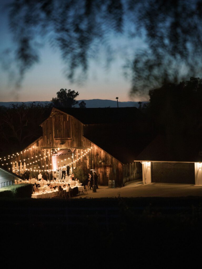 Evening wedding reception beneath string lights at Greengate Ranch & Vineyard