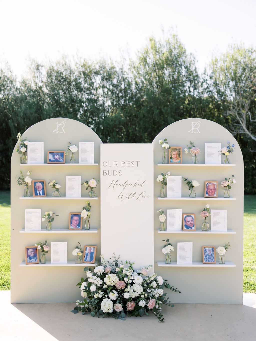 Custom sage wedding seating chart with LR monogram, bud vases and family photographs