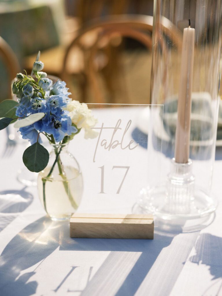 Clear acrylic table number 17 with floral wedding centerpiece