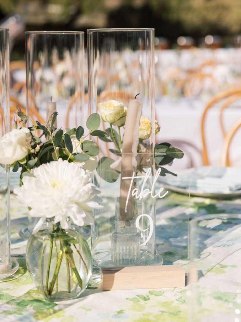 Clear acrylic table number 9 displayed over Hydrangea Meadow wedding linen